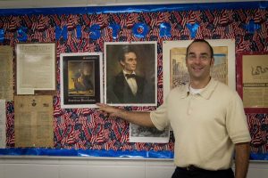 Mr. Wolf excitedly points to a photo of the American Revolution.