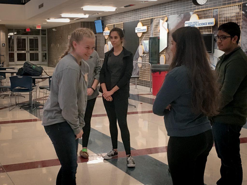 New member Nora Hagler, '20, tries to make Shah smile in "Honey, I love you," where the person on the inside must make a person on the outside smile. Shah says it's "very hard not to burst out laughing during the game,” but she tries to keep a straight face. 